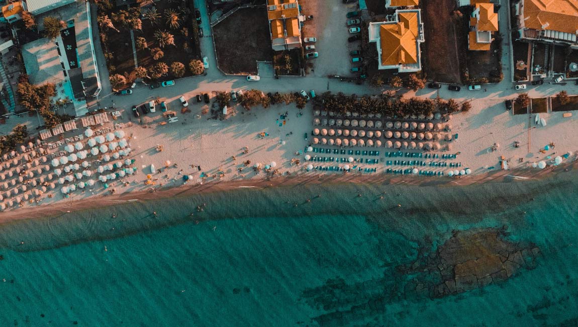 Beach in Pefkochori, Halkidiki with turquoise waters and seaside accommodation