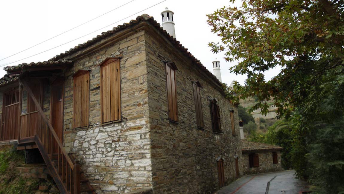 Traditional stone house with wooden shutters in Old Nikiti, Halkidiki