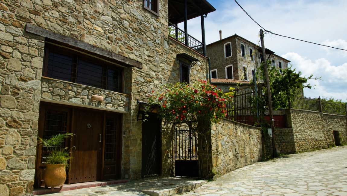 Traditional stone houses and a cobbled street in Parthenonas, Halkidiki